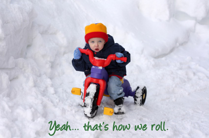 Kid on a tricycle in the snow